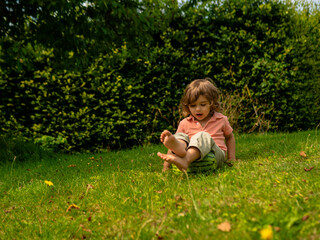 A little toddler boy is eating fresh watermelon on a sunny day on his summer holidays at the countryside in a cottage in England