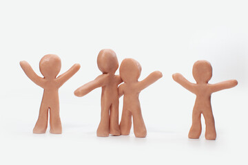 clay figures holding each other