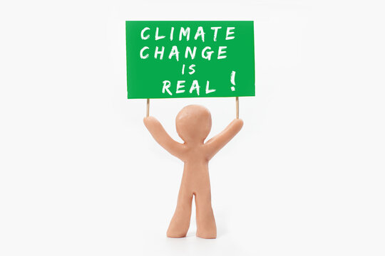 clay figure holding climate change banner