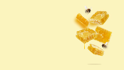 Flying pieces of honeycomb, drop of honey and bees on a yellow background. A conceptual composition of floating honeycombs. Healthy food, square image. Creative layout design. copy space