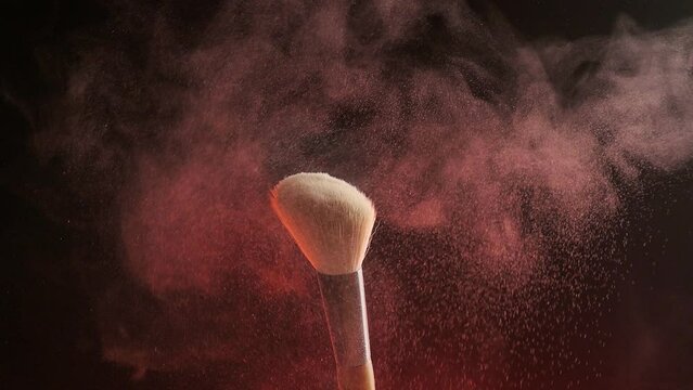 Make up brush and colored powder particles exploding. Shot with high speed camera, phantom flex