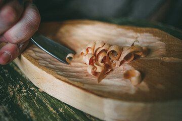 Wood carving in creativity workshop, carving craftsmanship, wooden shaving, tradition worker