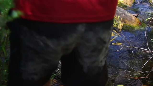 A close up shot from a man's feet crossing a creek during dry season in Minas Gerais State, Brazil