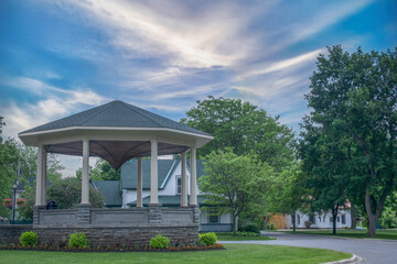 A small town hexagonal wooden bandstand in a treed park, daytime, nobody - obrazy, fototapety, plakaty