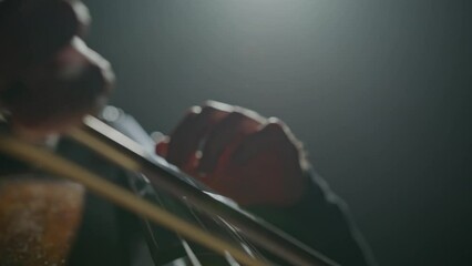Footage male hands playing cello violoncello . Musician Woman plays in beautiful contrabass on stage in concert . Close up . Shot on Red Komodo movie camera