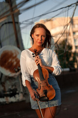 Ukrainian violinist girl on the roof of an apartment building