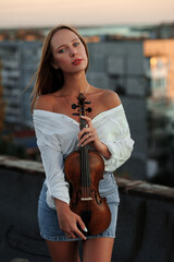 Ukrainian violinist girl on the roof of an apartment building
