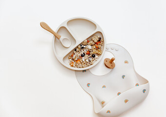 Healthy breakfast for kids - oatmeal for baby food. Serving food, baby tableware, feeding concept. Instagram use