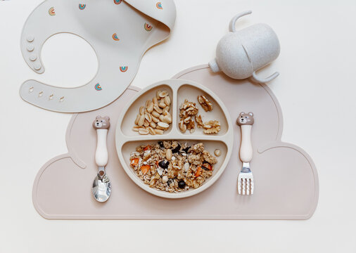 Healthy breakfast for kids - oatmeal for baby food. Serving food, baby tableware, feeding concept. Instagram use
