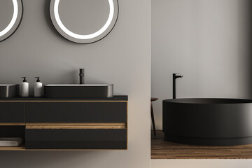 Close up of double sink with oval mirrors- hanging in on dark gray wall, modern cabinet with black faucets in minimalist bathroom. 3d rendering