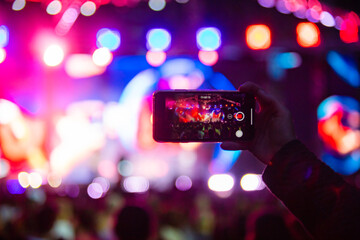 Fototapeta na wymiar Hands with phones on concert, atmosphere on concert