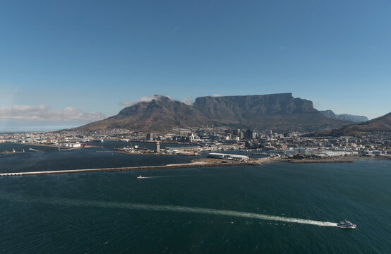 Cape Town South Africa. 2022. Aerial view of Table Mountain and city of Cape Town . In foreground passenger ferry bound for Robben Island.