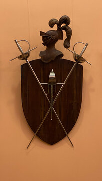 black shield and swords in the orange wall 