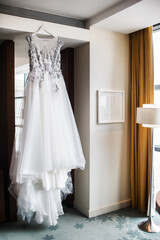 Fototapeta na wymiar Wedding dress on the wall in the hotel room
