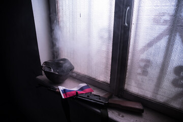 Conceptual photo of war between Russia and Ukraine. Ukraine and Russia flags on windowsill at...