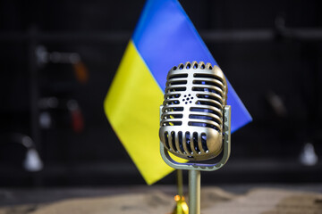 Microphone on a background of a blurry flag Ukraine close-up