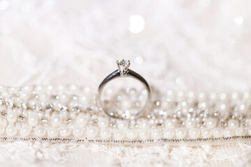 Wedding ring on wedding dress background