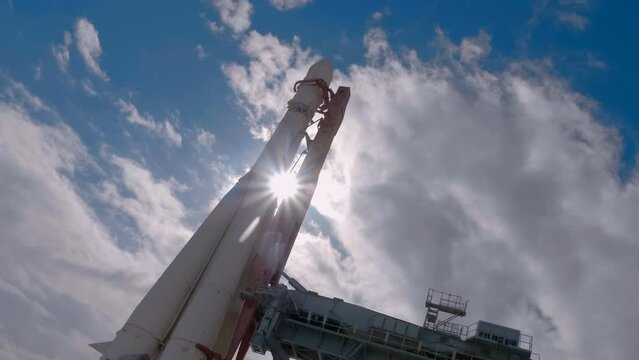 Space rocket at the launch complex against a blue sky with clouds. Shot in motion