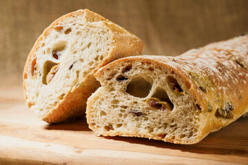 Fresh Mediterranean style bread with olives. Premium quality bakery product. Brown color background.