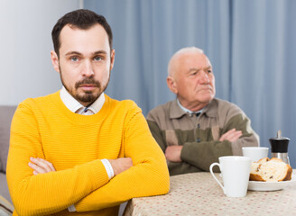 Aged father arguing with her adult son at home