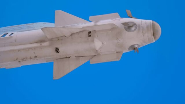 On the wing of a Russian fighter controlled missile "air-to-air", "air-to-ground", of radar or thermal homing against a blue sky with clouds. Shot in motion