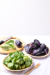 cabbage sprout (green and purple) on natural plate, Organic vegetable