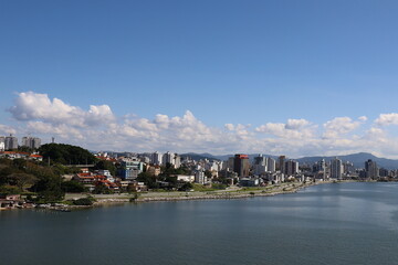 Fototapeta premium City on the ocean coast sea and mountains promenade sandy Brazil Florianopolis beautiful view from the water to tall buildings from a height