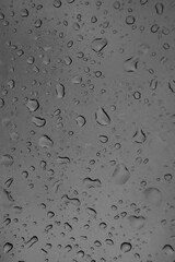 gray background, water drops on the glass in the photo