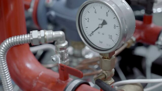 Modern manometers and thermometers for monitoring parameters in the system of hot and cold water supply and home heating. Closeup. Shot in motion