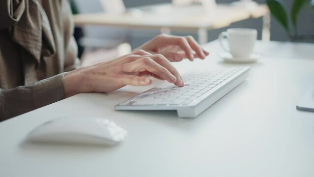 Female hands writing on keyboard of computer in office. Caucasian woman typing text on keyboard. Electronic mail, preparation of presentation, browsing. Shopping online, e-commerce. Indoors