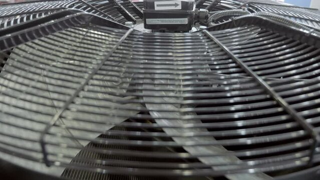 Power supply cooling fan of high-power industrial equipment. Closeup. Shot in motion
