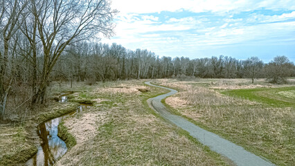 Fototapeta na wymiar A trail follows a stream in springtime