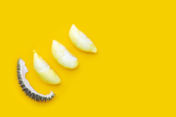 Fresh ripe cut durian on yellow background.