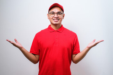 Young handsome asian delivery man wearing delivery uniform smiling showing both hands open palms,...