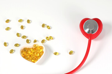 Fish oil and stethoscope, body care, heart health, healthy vitamins