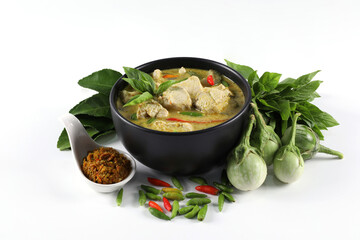 Thai food. Chicken green curry put in a black bowl isolated on white background. Green curry chicken paste with ingredients.