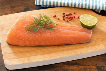 raw salmon fillet on a wooden board