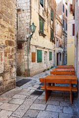 Fototapeta na wymiar An outdoor cafe on the narrow streets of the Mediterranean riviera. Split, Dalmatia, Croatia