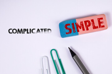 Complicated and Simple concept. Eraser and office supplies on a white background