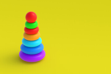 Toy pyramid tower on yellow background. Children education. Educational games. Preschool development. Copy space. 3d render