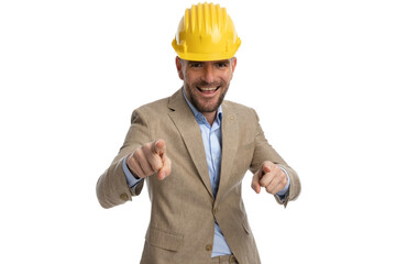 attractive businessman with helmet pointing fingers and laughing