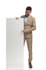middle aged man pointing finger and showing empty board