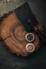 top view of old wooden chopping board with cleaver and salt and pepper