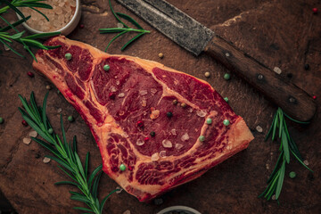 old vintage wooden chopping board with red bloody meat on top
