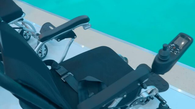 New Samples Of Modern Comfortable Motorized Wheelchairs For The Disabled At The Exhibition. Closeup. Shot In Motion