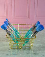 blue brushes for makeup in basket
