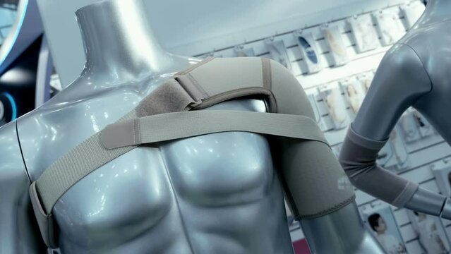 On the mannequin there is an elastic bandage on the shoulder for the treatment of an injury or with heavy loads on the arm. Closeup. Shot in motion