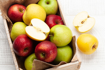 Colorful ripe apple fruits in box