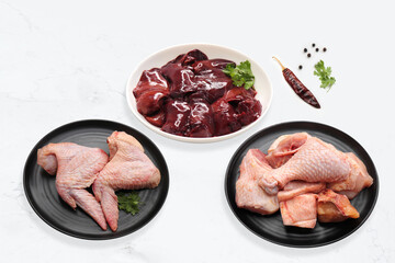 Raw Chicken meat, Chicken wings, chicken liver, and drumsticks with Indian spices. complete animal based protein source. copy space. Non vegitarian food banner. 