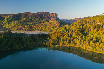 Lake Bled on a beautiful spring morning with mist and low clouds at sunrise